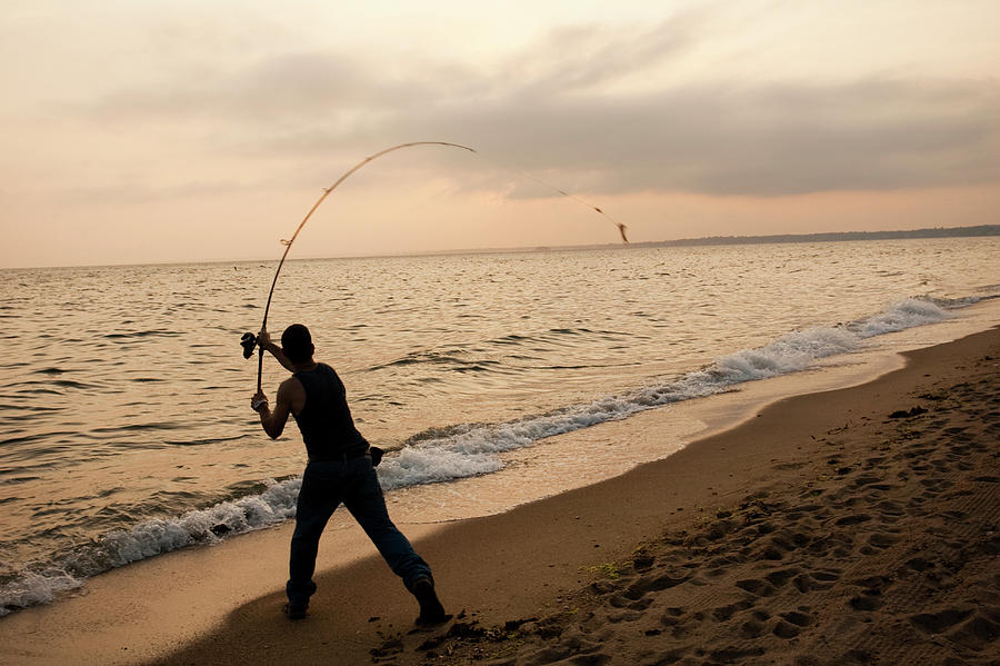 A Man Fishing Photograph by Carl D. Walsh - Pixels