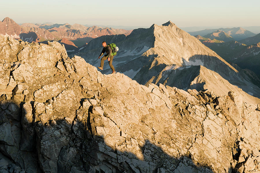 Landscape Photograph - A Man Hiking Along Rocky Ridge by Kennan Harvey