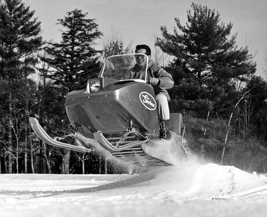 A Man Riding A Snowmobile Photograph by Underwood Archives