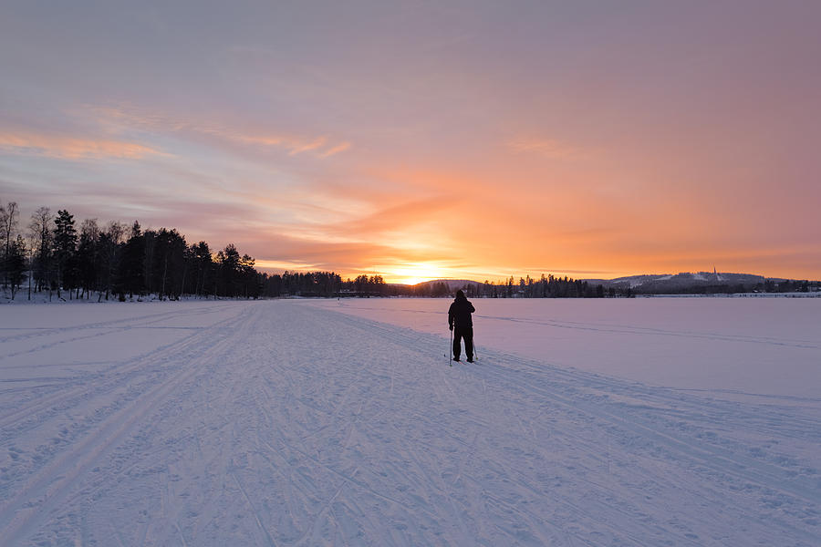 A man skiing into the sunset Photograph by Sami Hurmerinta