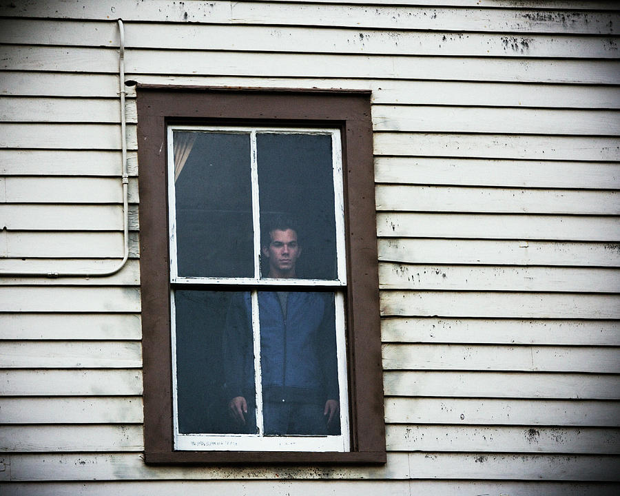 A Man Standing In Window Of Old House Photograph by Ron Koeberer