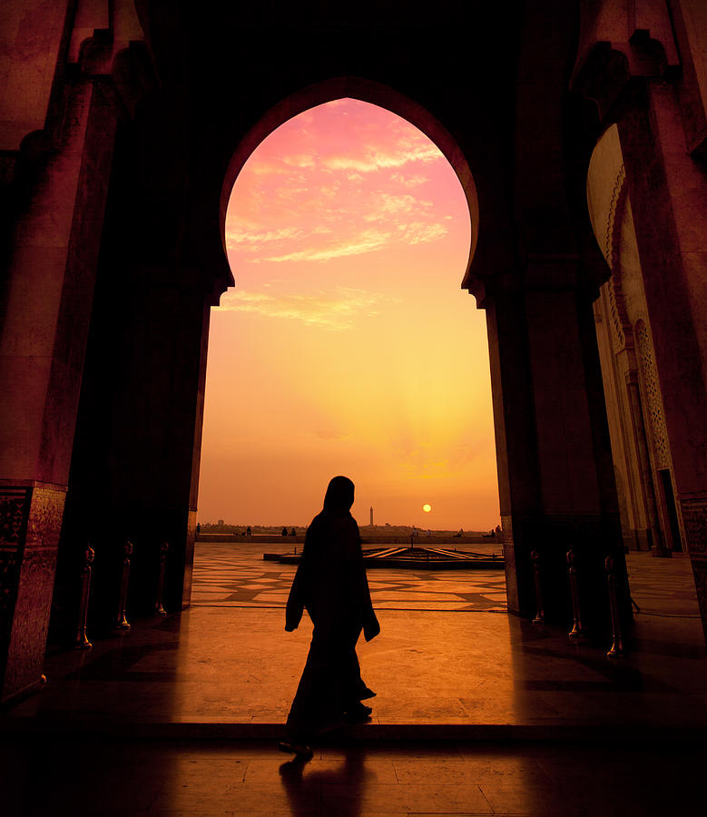 A man walking in a mosque during a sunset Photograph by Maravic