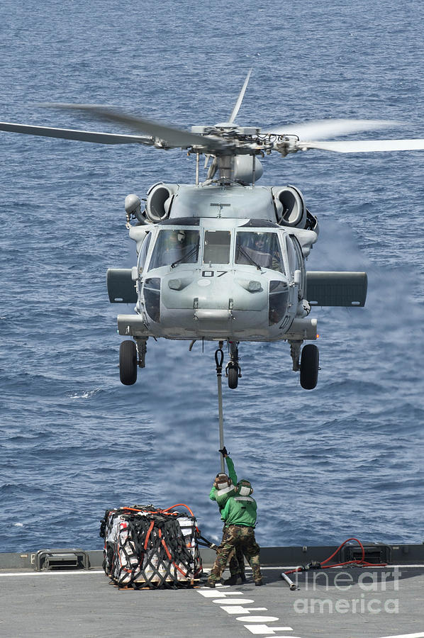 Transportation Photograph - A Mh-60s Sea Hawk Helicopter Lifts by Stocktrek Images