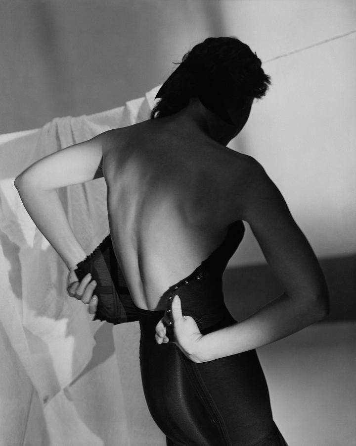 A Model Fastening Her Brassiere Photograph by Horst P. Horst