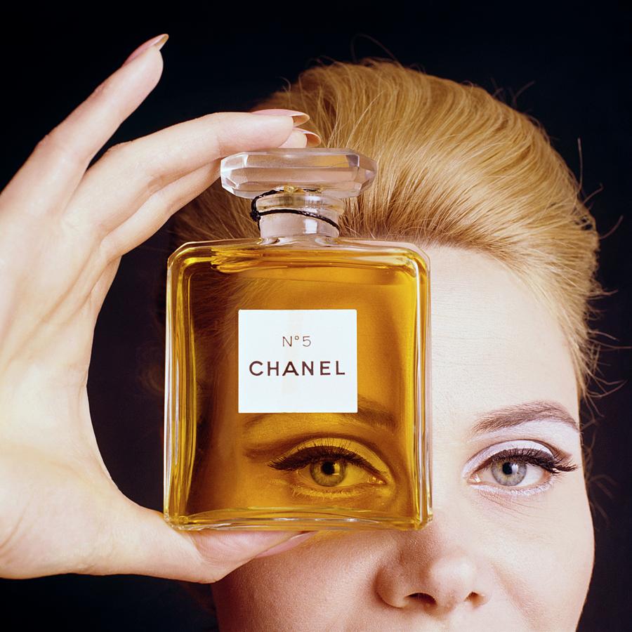 A Model Holding A Bottle Of Perfume By Fotiades