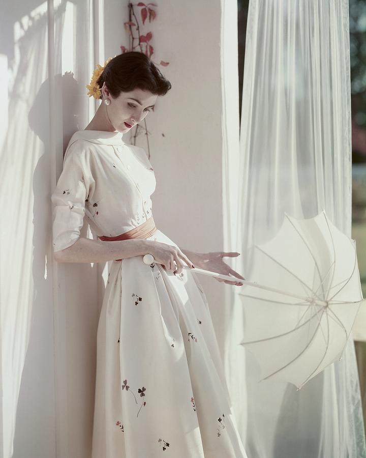 A Model Holding A Parasol Photograph by Horst P. Horst