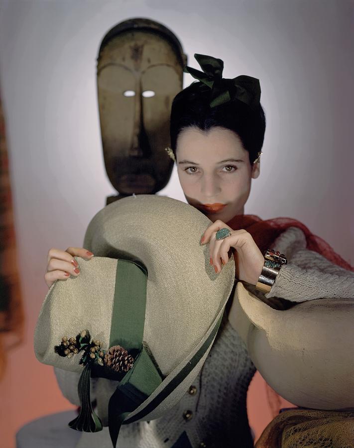Hat Photograph - A Model Holding A Sun Hat by Horst P. Horst