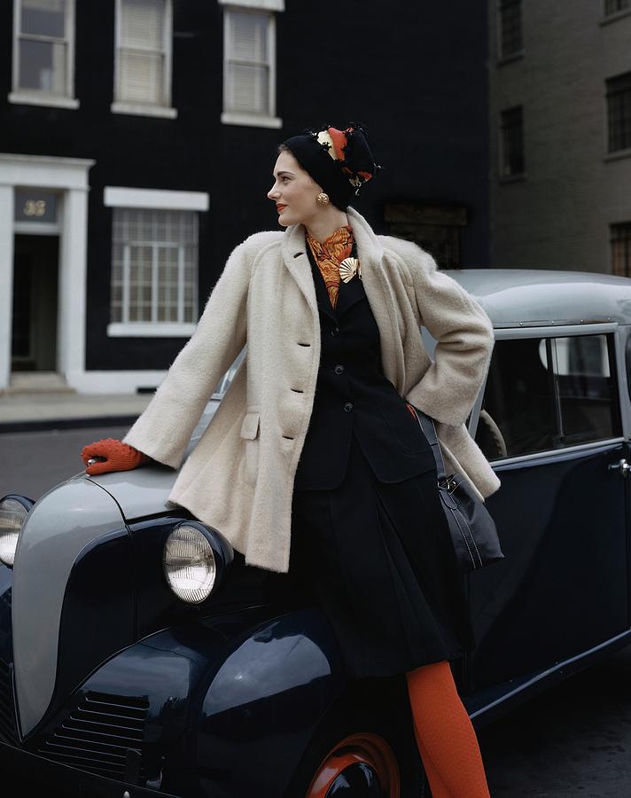 A Model Leaning On A Vintage Car Photograph by John Rawlings