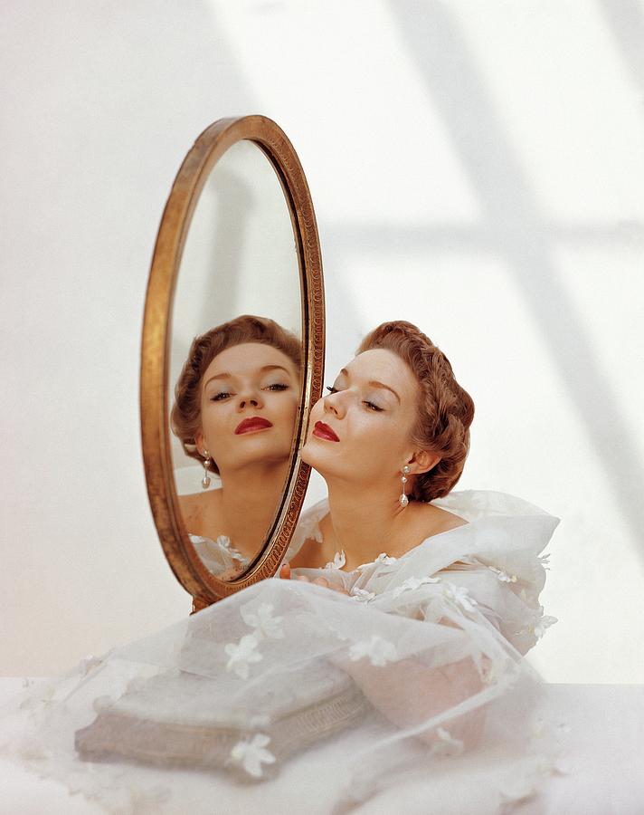 A Model Looking Into A Mirror Photograph by John Rawlings
