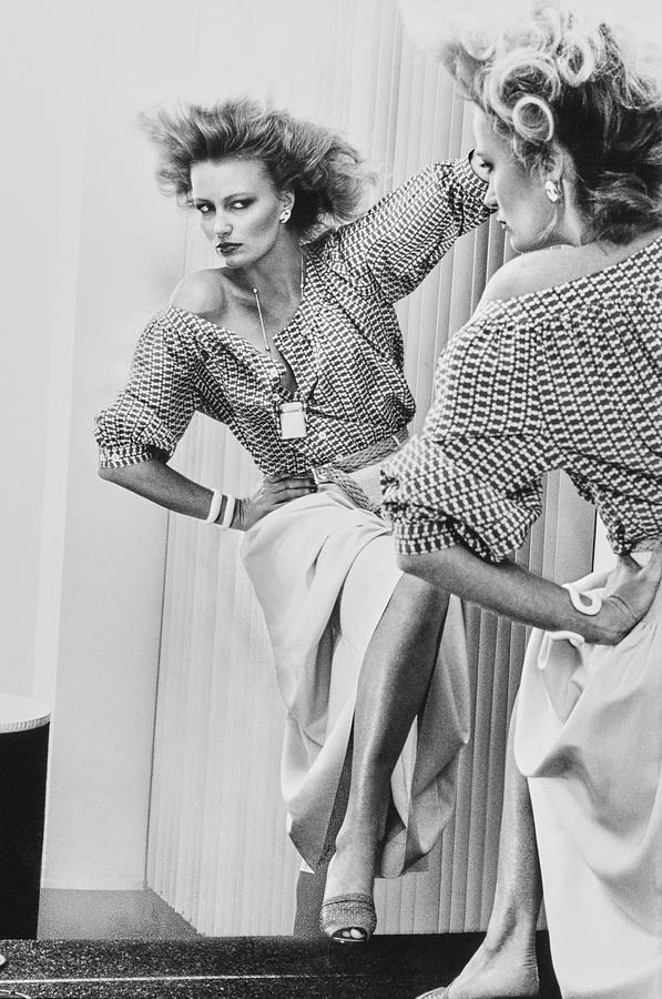 A Model Looks Into A Mirror Wearing Donna Karan Photograph by Chris von Wangenheim