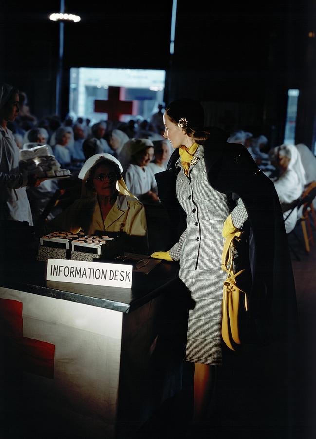 A Model Posing By An Information Desk Photograph by Horst P. Horst