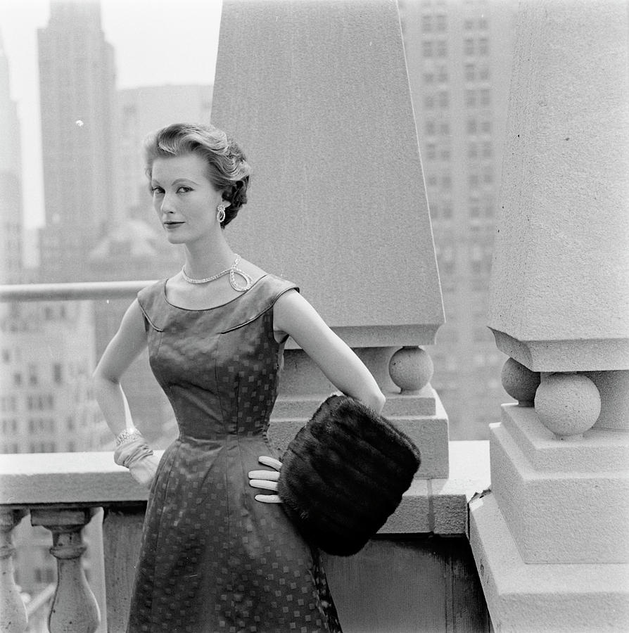 A Model Standing Against A Rooftop Column In An Photograph by Richard Rutledge A Model Standing Against A Rooftop Column In An Photograph by Richard Rutledge