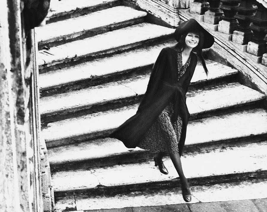 A Model Walking Down A Staircase Photograph by Henry Clarke