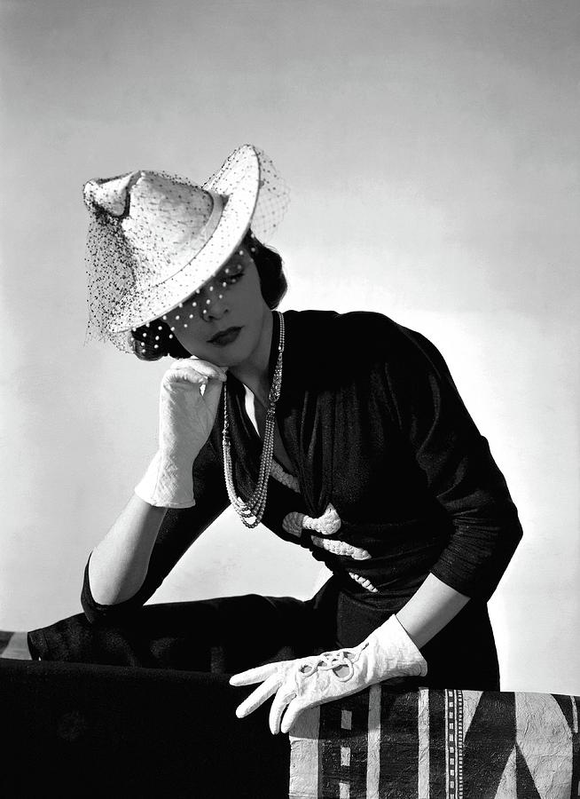 A Model Wearing A Crepe Dress And Hat Photograph by Horst P. Horst