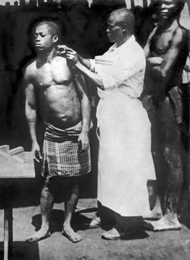 Black And White Photograph - A Native Being Inoculated by Underwood Archives