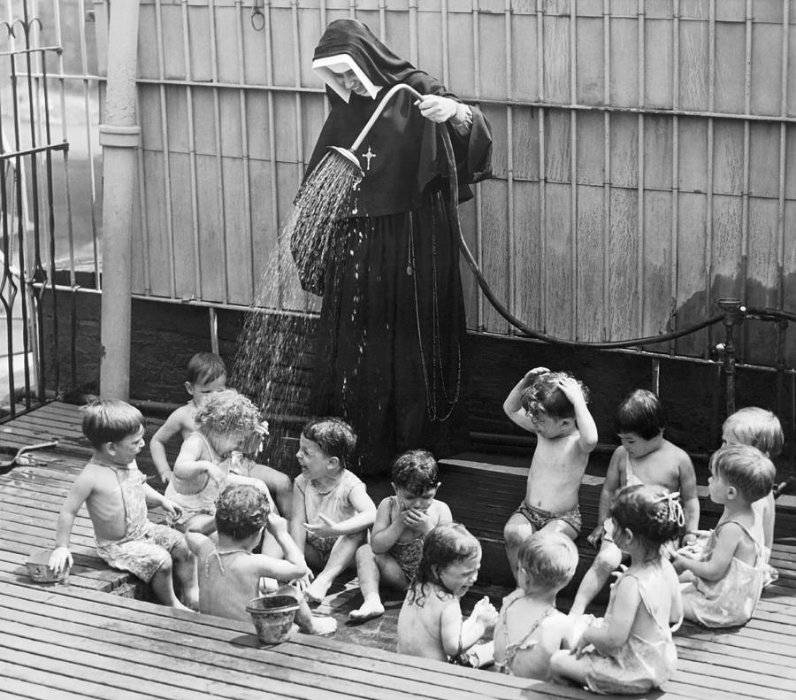 A Nun Watering Children Photograph by Underwood Archives