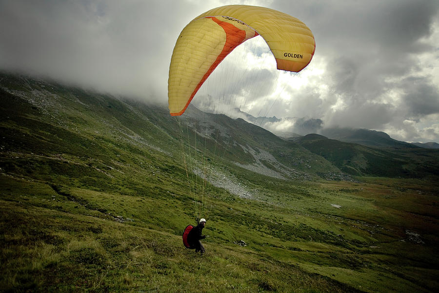 Nature Photograph - A Paraglider Soaring On A Cloudy Day by Olivier Renck