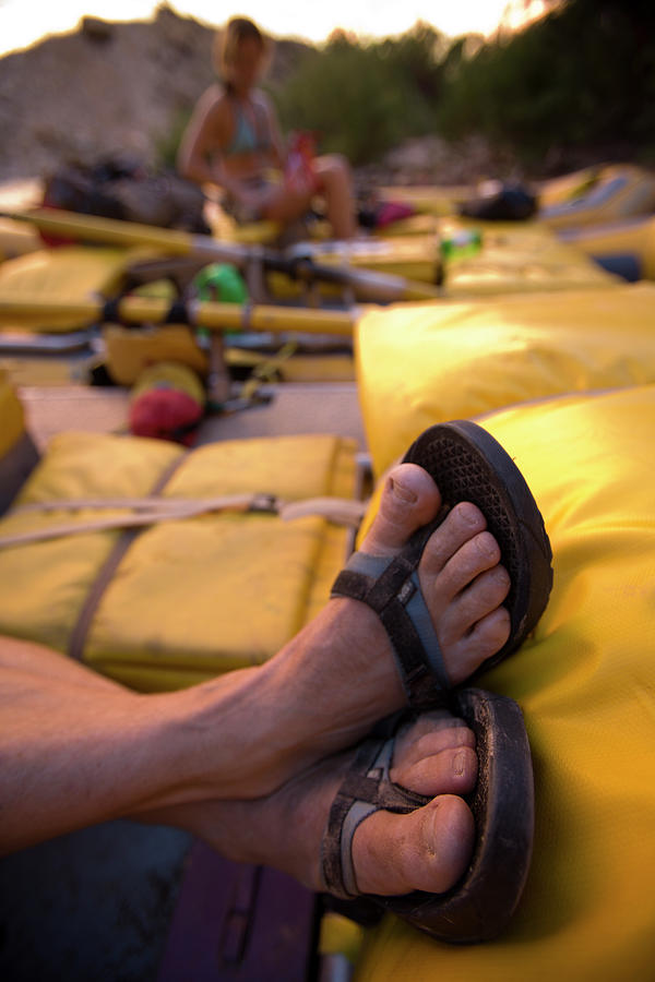 Action Photograph - A Persons Crossed Feet In Sandals by Corey Rich Action Photograph - A Persons Crossed Feet In Sandals by Corey Rich