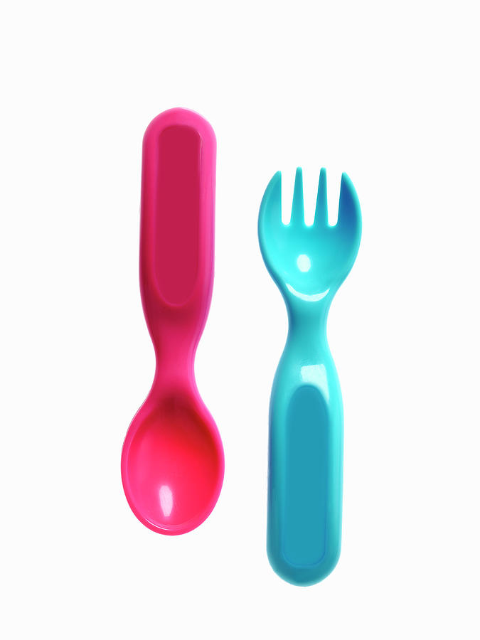 A Pink Plastic Baby Spoon And A Blue Photograph by Mint Images - David Arky