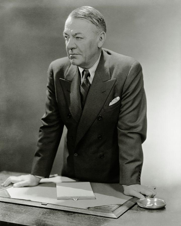 A Portrait Of Hugh Johnson Leaning Against A Desk Photograph by Lusha Nelson