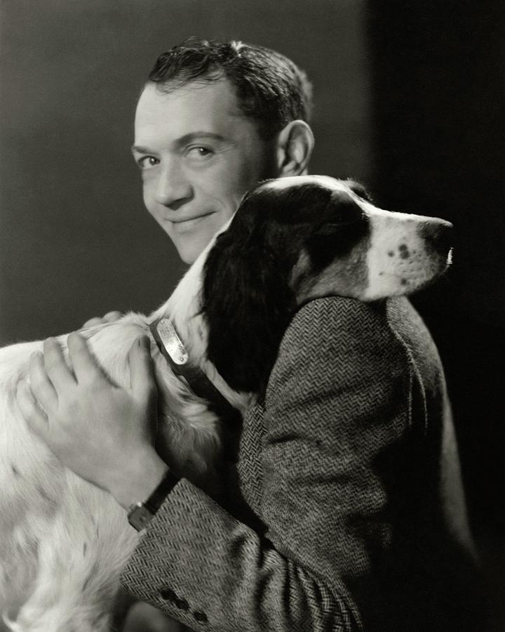 A Portrait Of John Held Jr. Hugging A Dog Photograph by Nickolas Muray
