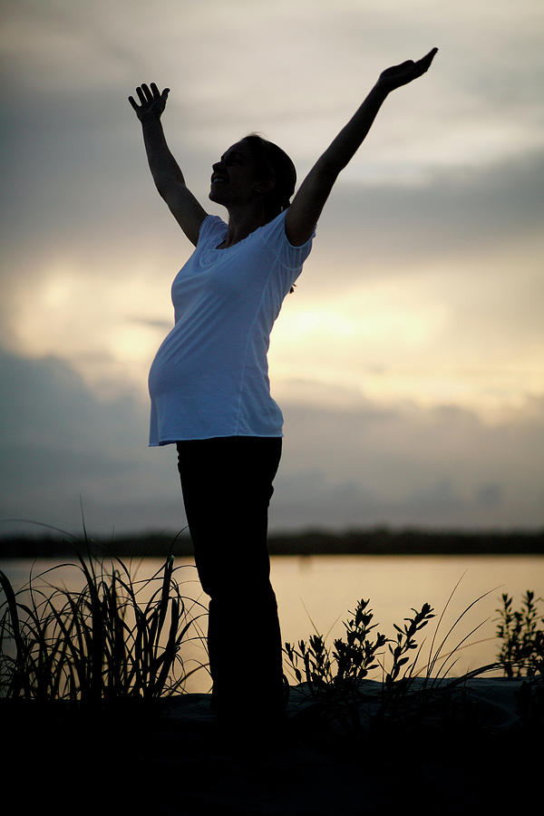 Sunset Photograph - A Pregnant Woman Stands In The Grass by Logan Mock-Bunting