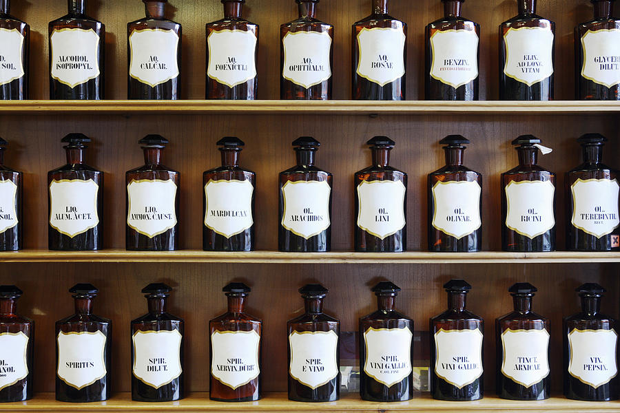A range of natural spirits, acids and oils in homeopathic pharmacy Photograph by Hemme