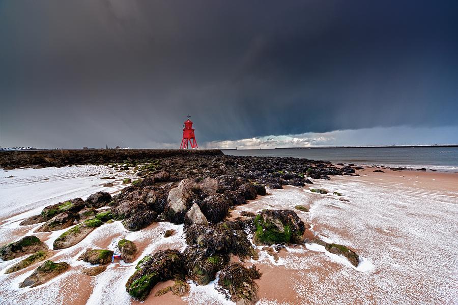 A Red Lighthouse Along The Coast Photograph by John Short