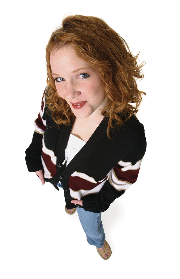 A Redheaded Caucasian Female Teenager In Jeans And A Black Sweater Smiles Up Into The Camera Photograph by Photodisc