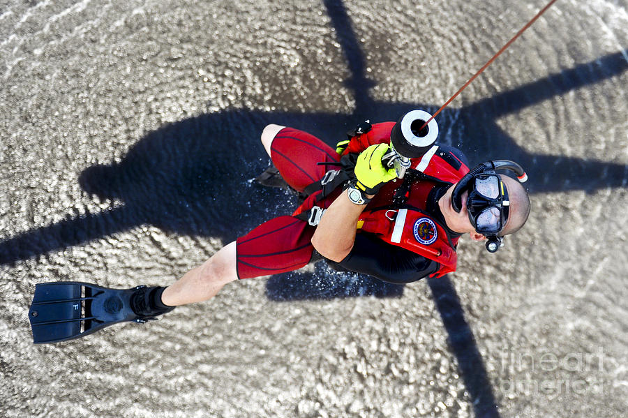 A Rescue Swimmer Gets Hoisted Into An Photograph by Stocktrek Images