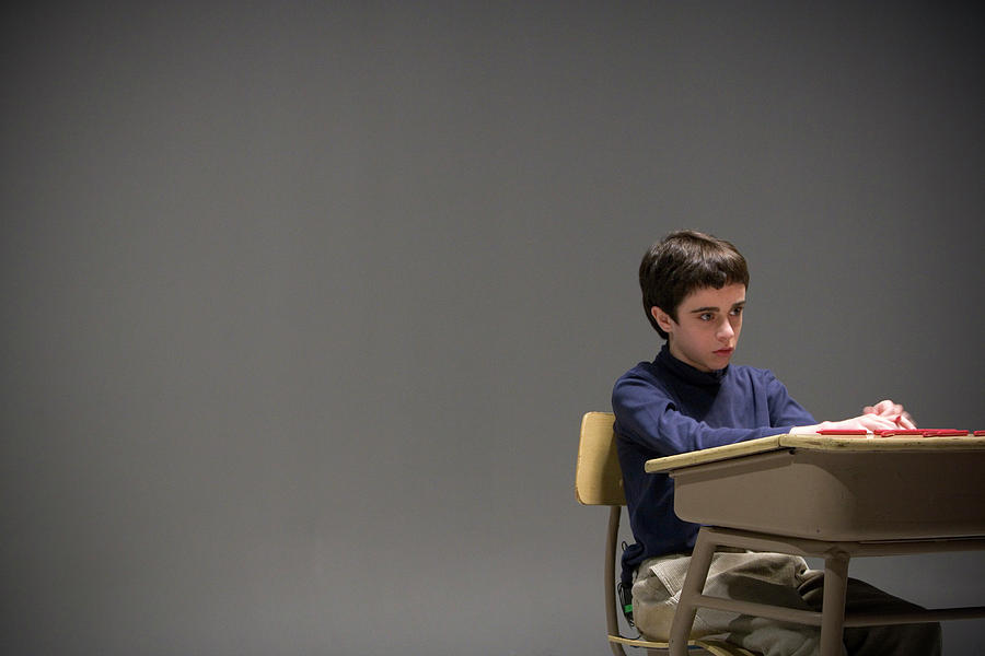 A School Boy Sitting At A Desk In Empty Photograph By Ron Koeberer