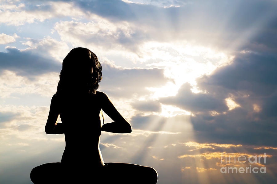 Sunset Photograph - A silhouette of a woman sitting in yoga position by Michal Bednarek