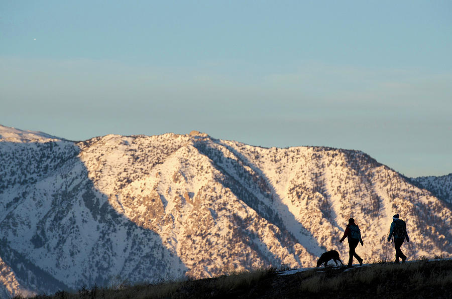 Winter Photograph - A Silhouette Of Two Female Hikers by Corey Rich