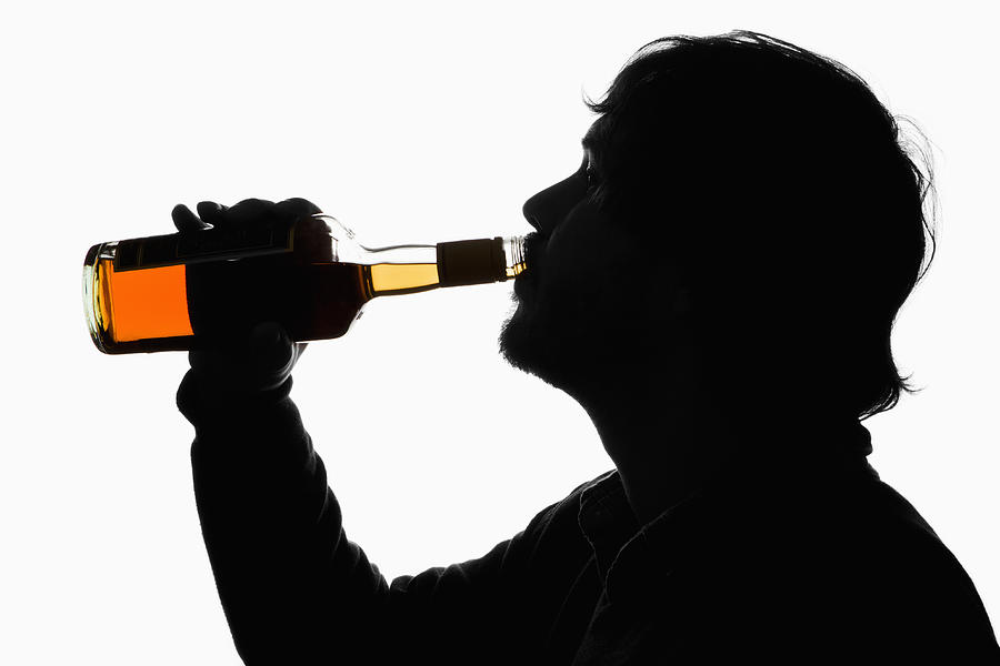 A silhouetted man drinking whiskey from the bottle Photograph by Epoxydude