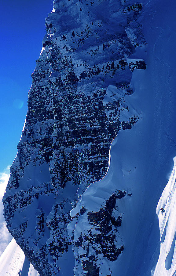 A Skier Drops From Snowy Cliff Photograph by Lucas Gilman A Skier Drops From Snowy Cliff Photograph by Lucas Gilman