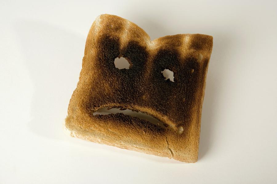 A slice of burnt toast with a sad face Photograph by Martin Diebel
