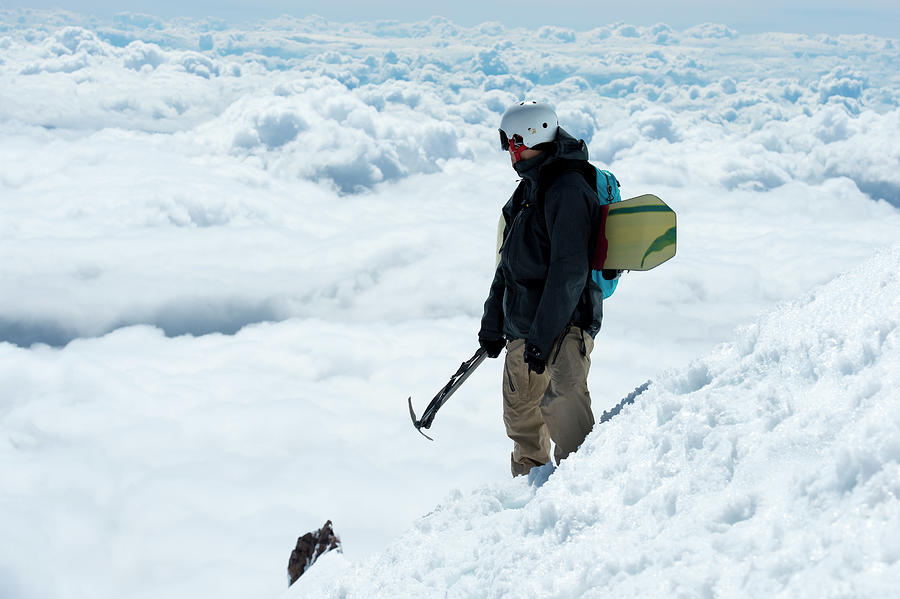 A Snowboarder Hiking Up Mt. Hood Photograph by Brandon Huttenlocher A Snowboarder Hiking Up Mt. Hood Photograph by Brandon Huttenlocher