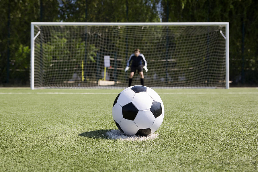 A soccer ball on a soccer field Photograph by Caspar Benson