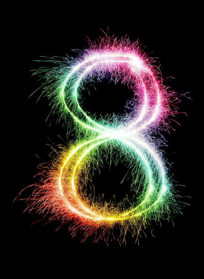 A sparkler forming the number 8 in a rainbow color Photograph by Viorika