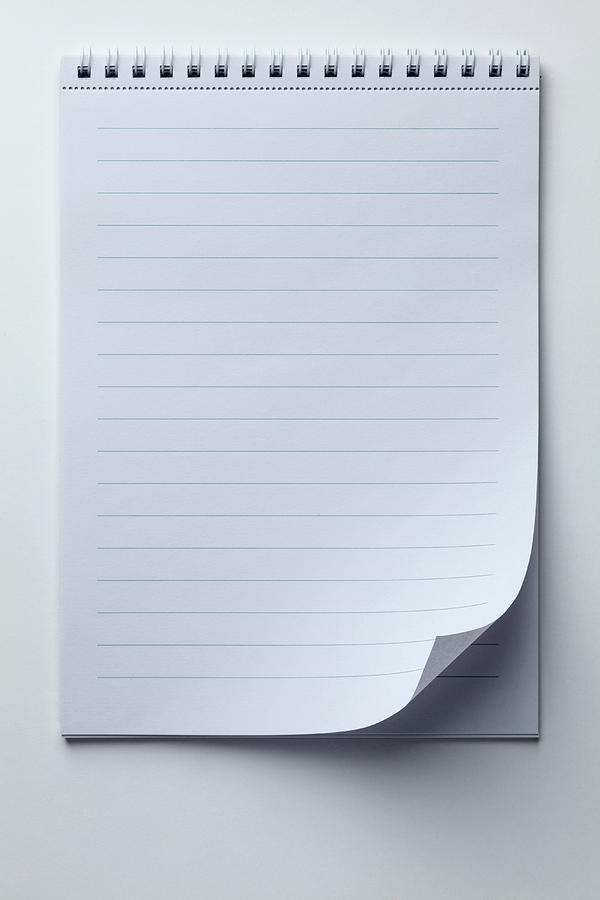 A Spiral Notepad With Lined Paper And A Photograph by Caspar Benson
