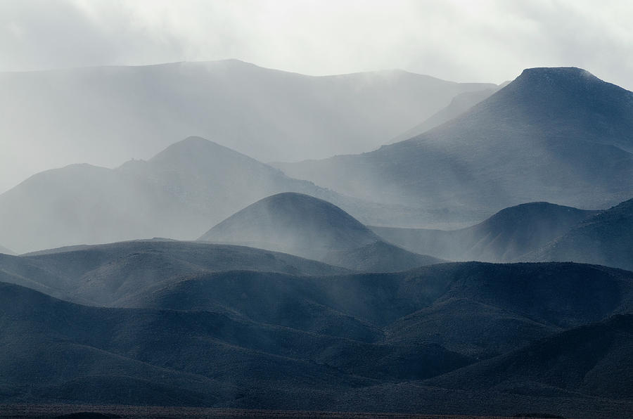 A Storm Engulfs The Mountains In The Photograph by Rachid Dahnoun