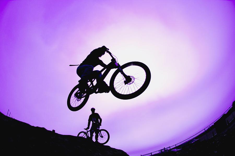 Sports Photograph - A Stunt Cyclist Silhouette by Corey Hochachka