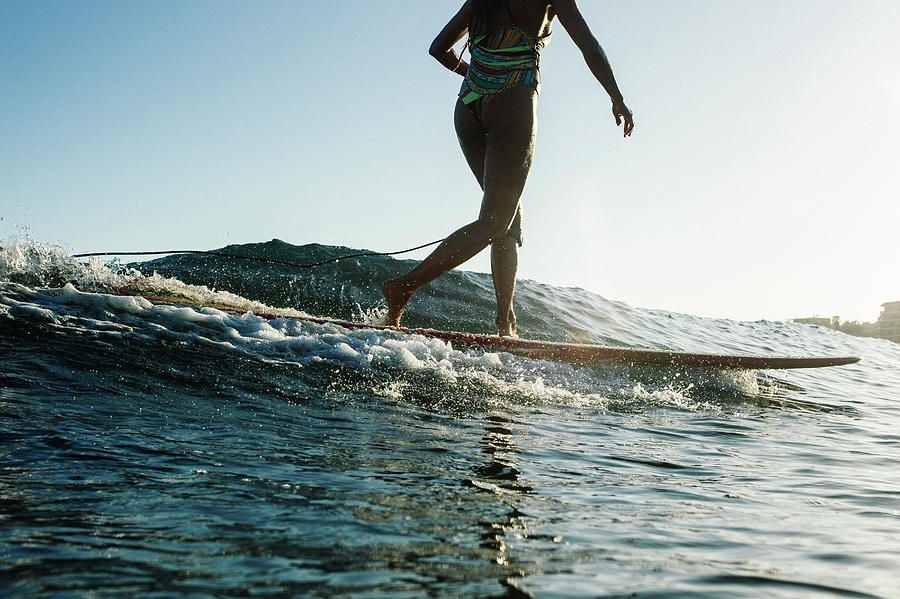 Nature Photograph - A Surfer Girl In A Bikini Surfs by Sergio Villalba