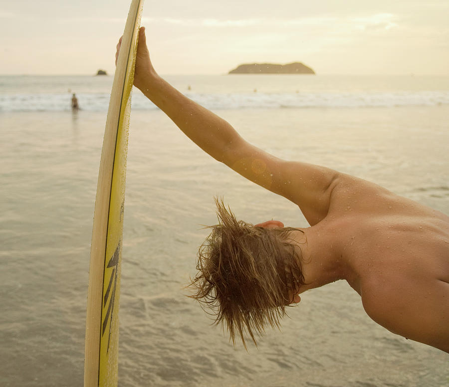 Beach Photograph - A Surfer On The Beach In Manuel by Lacey Ann Johnson