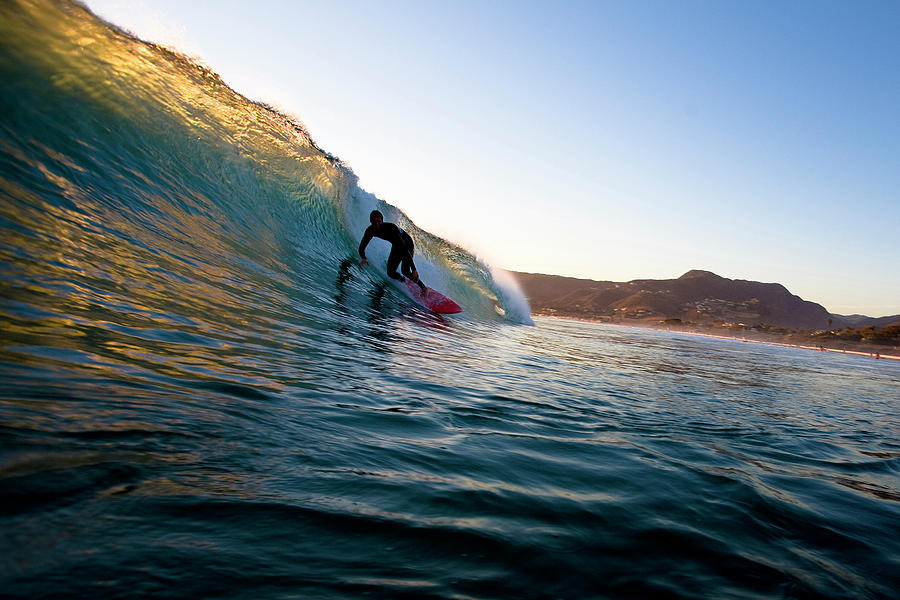 A Surfer Riding A Red Surfboard Sets Photograph by Kyle Sparks