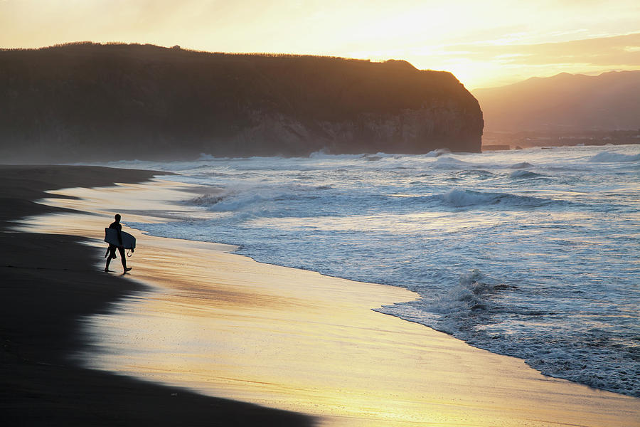 A Surfer Walks To The Water At Sunrise Photograph by Carl Bruemmer