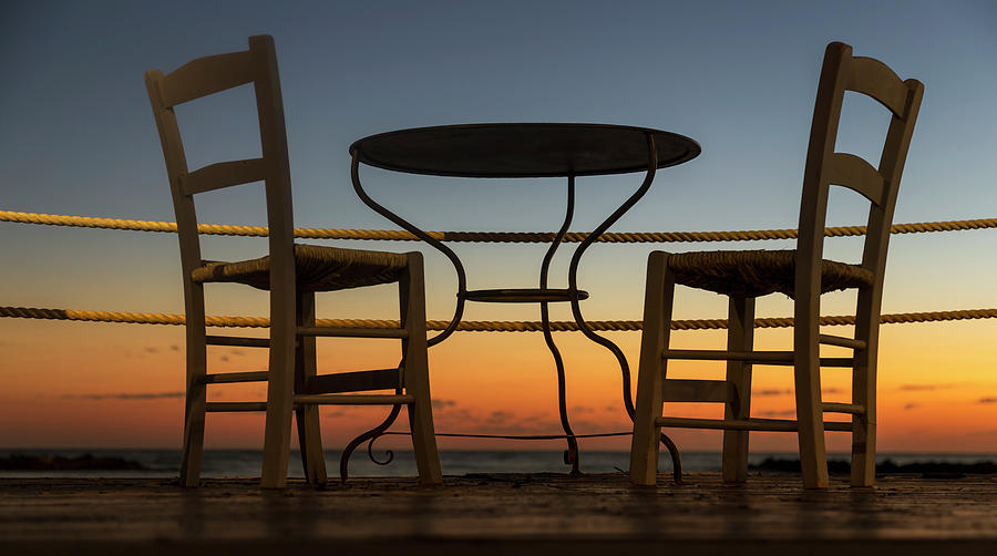 A Table And Chairs On A Patio Photograph by John Short