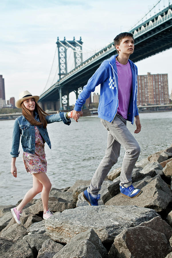 New York City Photograph - A Teen Couple Walking On The Rocks by Olivier Renck