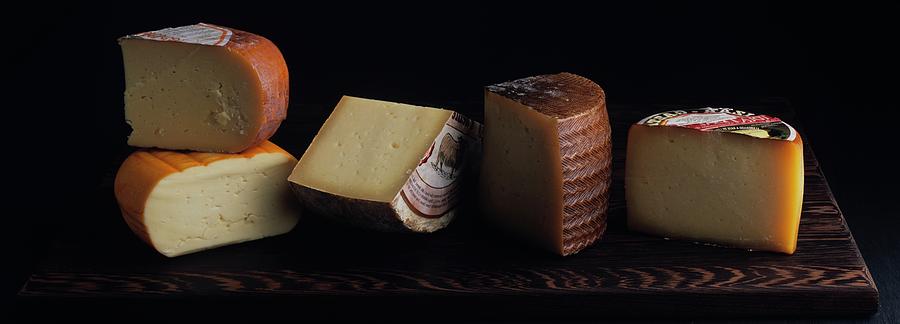 A Variety Of Cheese On A Cutting Board Photograph by Romulo Yanes