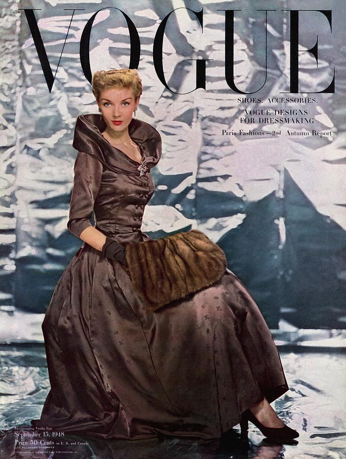 A Vogue Cover Of A Woman Wearing A Brown Dress Photograph by Erwin Blumenfeld